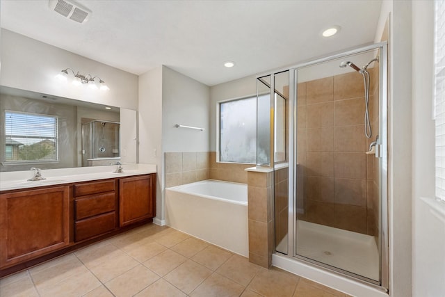 full bathroom with tile patterned flooring, a sink, and a shower stall