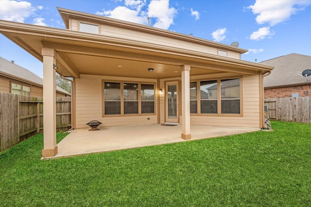 rear view of house with a patio area, fence, and a yard