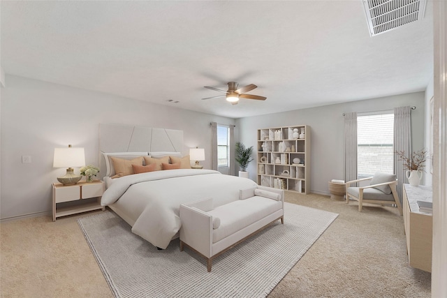 bedroom with light carpet, multiple windows, and visible vents