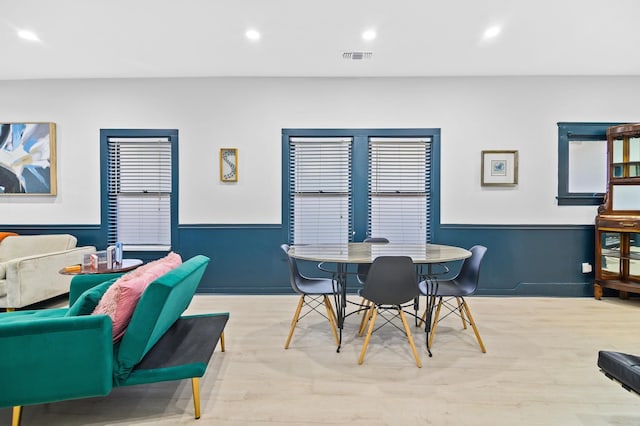 dining space with a wealth of natural light and light hardwood / wood-style flooring