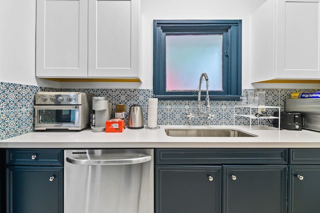 kitchen with stainless steel dishwasher, sink, decorative backsplash, and white cabinets