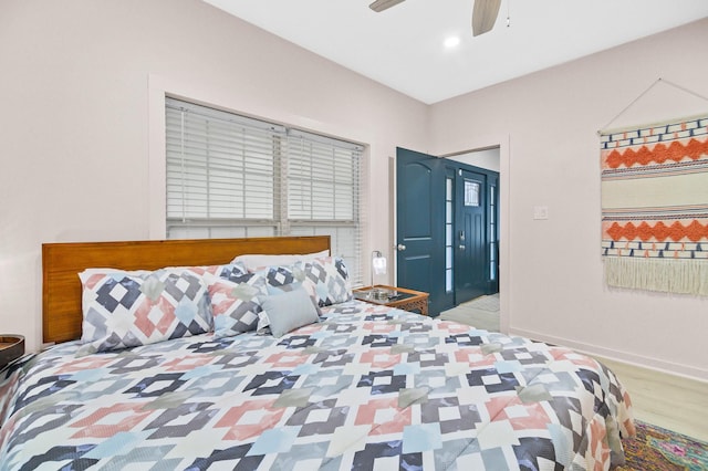 bedroom with light hardwood / wood-style flooring and ceiling fan