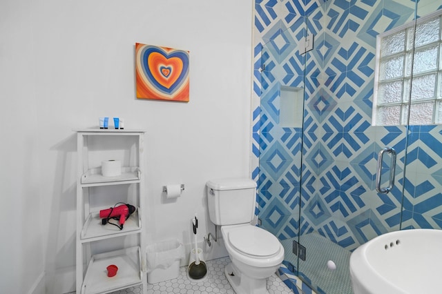 bathroom with walk in shower, toilet, and tile patterned flooring