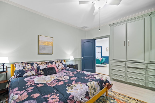 bedroom featuring ceiling fan, ornamental molding, and light hardwood / wood-style floors