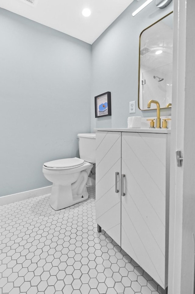 bathroom featuring tile patterned floors, vanity, and toilet