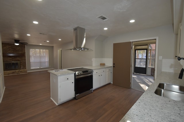 kitchen with white cabinetry, island exhaust hood, light stone counters, and stainless steel electric range