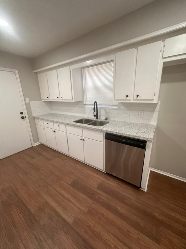 kitchen featuring tasteful backsplash, white cabinetry, dishwasher, sink, and dark wood-type flooring