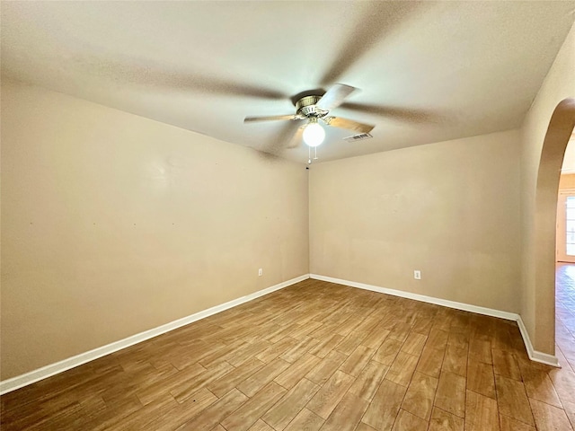 unfurnished room with a textured ceiling, ceiling fan, and light wood-type flooring