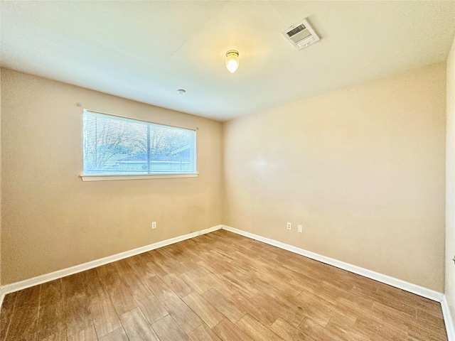 unfurnished room with hardwood / wood-style floors