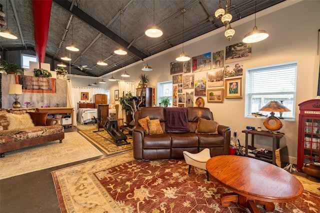 living room featuring concrete flooring and a towering ceiling