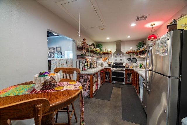 kitchen with appliances with stainless steel finishes, light stone countertops, and wall chimney range hood