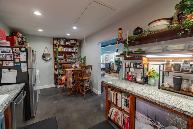 kitchen with light stone counters and stainless steel appliances