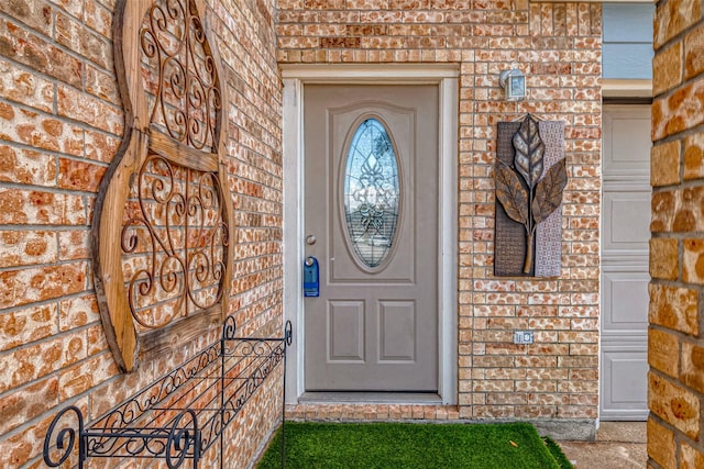 entrance to property with brick siding