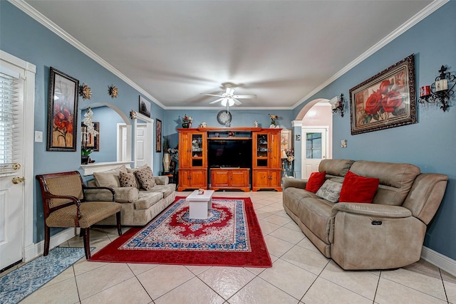 living area with arched walkways, light tile patterned floors, baseboards, and crown molding