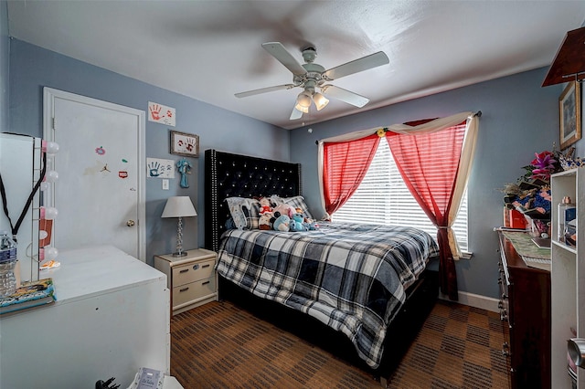 bedroom with a ceiling fan and baseboards