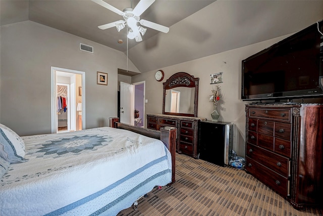 carpeted bedroom featuring lofted ceiling, visible vents, and a ceiling fan