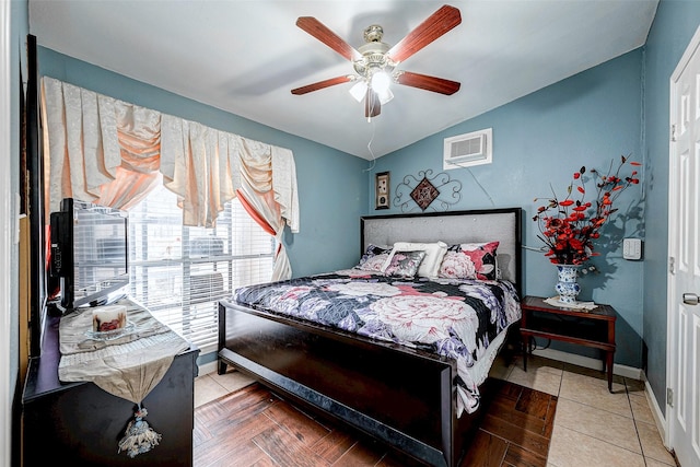 bedroom with a wall unit AC, ceiling fan, baseboards, and vaulted ceiling