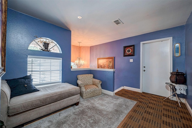 living area with baseboards, visible vents, a notable chandelier, and carpet flooring