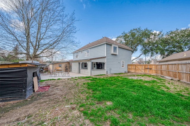 rear view of property with a yard, a fenced backyard, and a patio