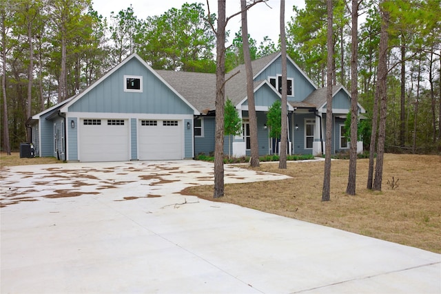 view of front of home featuring central AC unit and a garage