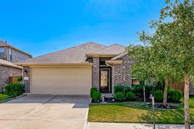 view of front of property featuring a garage and a front lawn