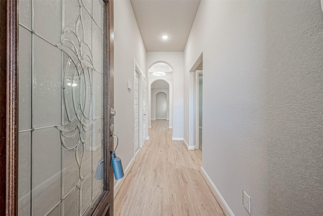 corridor with light hardwood / wood-style floors