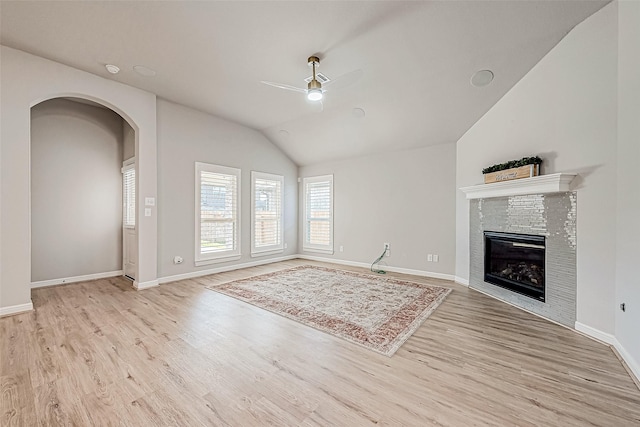 unfurnished living room with vaulted ceiling, light hardwood / wood-style floors, and ceiling fan