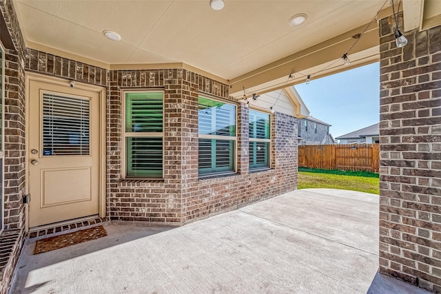 view of exterior entry featuring a patio area