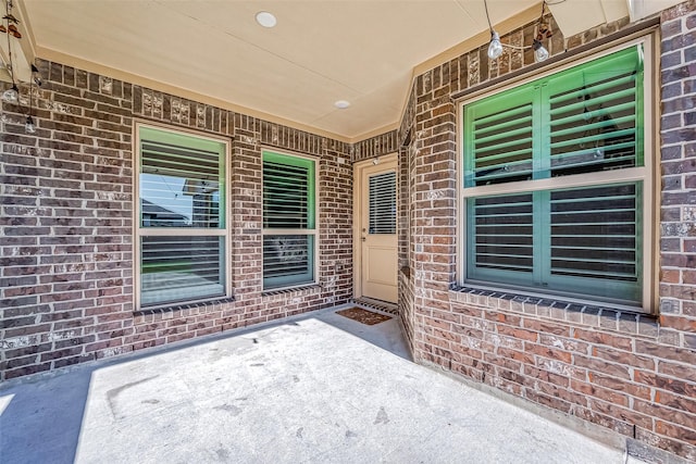 property entrance featuring a patio area