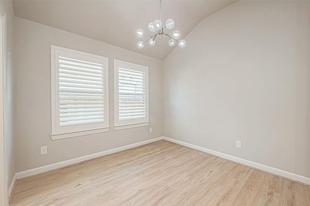 unfurnished room featuring lofted ceiling, a chandelier, and light wood-type flooring