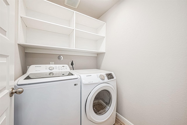 clothes washing area with independent washer and dryer