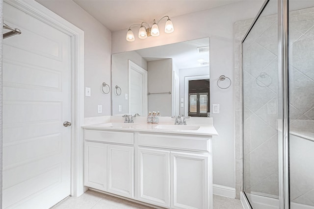 bathroom with tile patterned flooring, vanity, and a shower with door