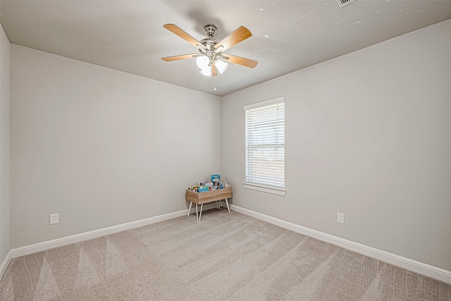 carpeted spare room featuring ceiling fan