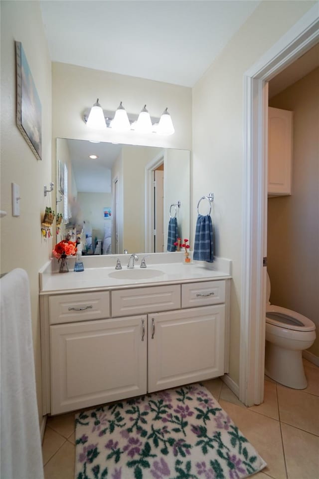 bathroom featuring vanity, toilet, and tile patterned flooring