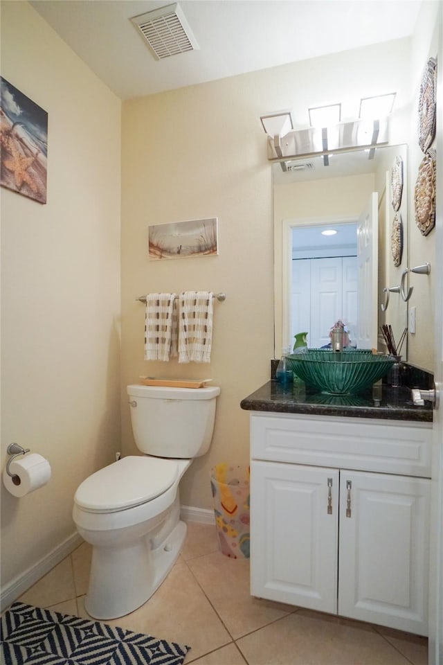 bathroom with vanity, tile patterned floors, and toilet