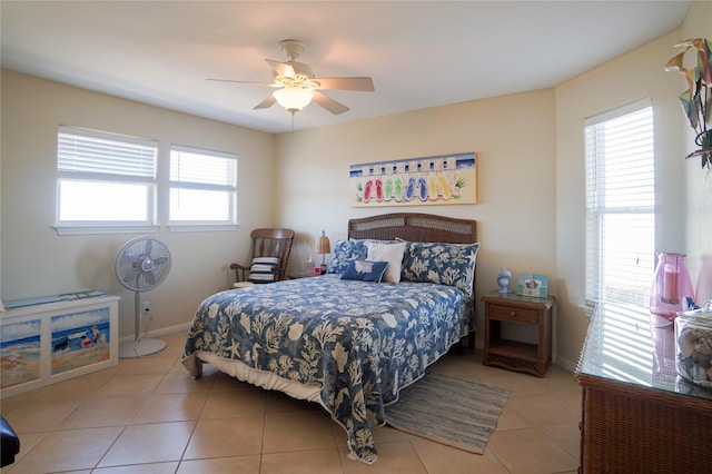 tiled bedroom with multiple windows and ceiling fan