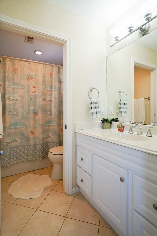 bathroom with tile patterned flooring, vanity, and toilet