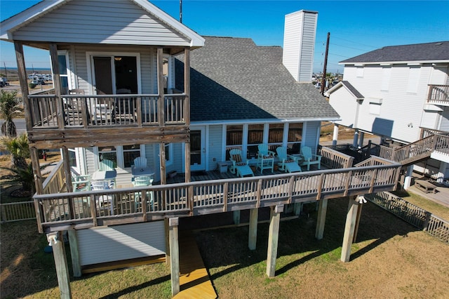 rear view of house with a wooden deck