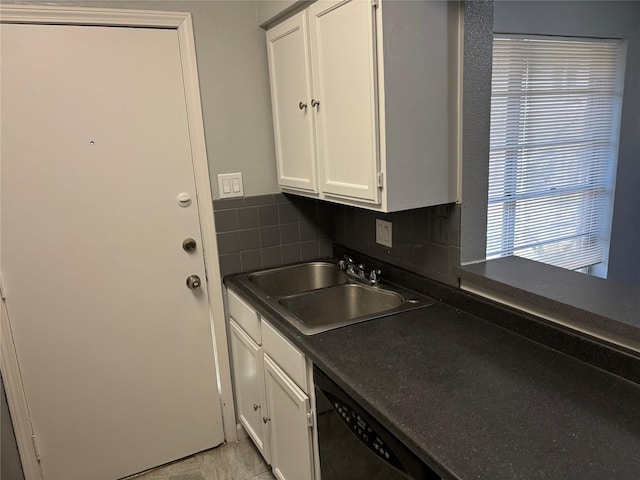 kitchen with black dishwasher, sink, white cabinets, and backsplash