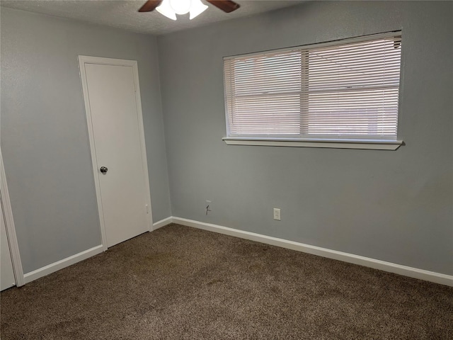 spare room featuring ceiling fan, carpet flooring, and a textured ceiling