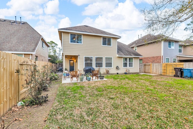 back of house with a yard and a patio area