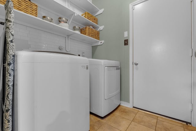 laundry room with light tile patterned flooring and washer and dryer