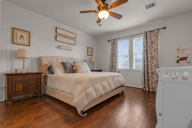 bedroom with dark wood-type flooring and ceiling fan