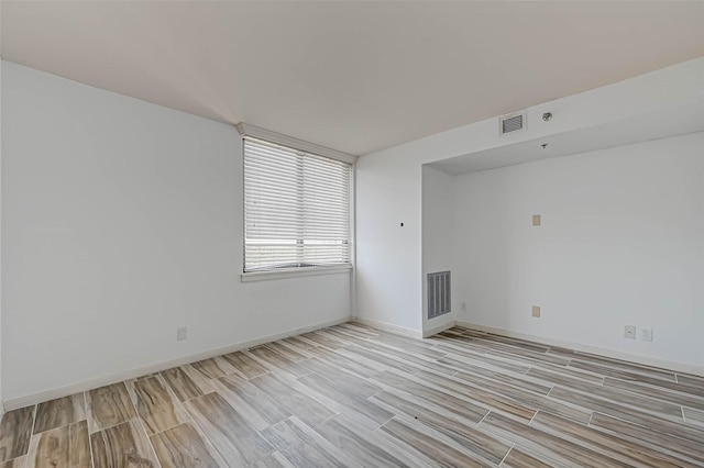 spare room featuring light wood-type flooring