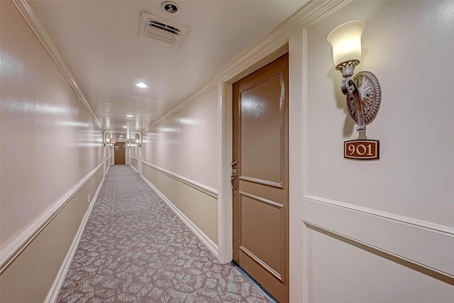 hallway featuring light colored carpet