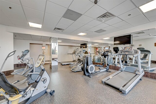 gym with a paneled ceiling