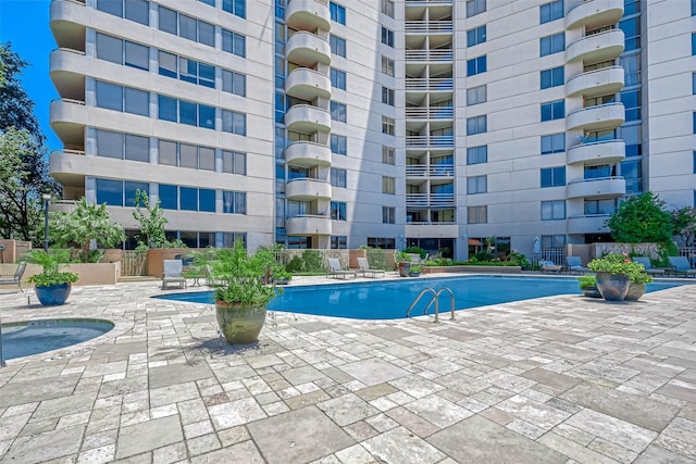 view of pool with a community hot tub and a patio area