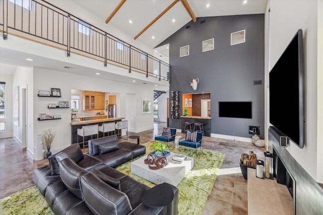 living room featuring beamed ceiling and high vaulted ceiling