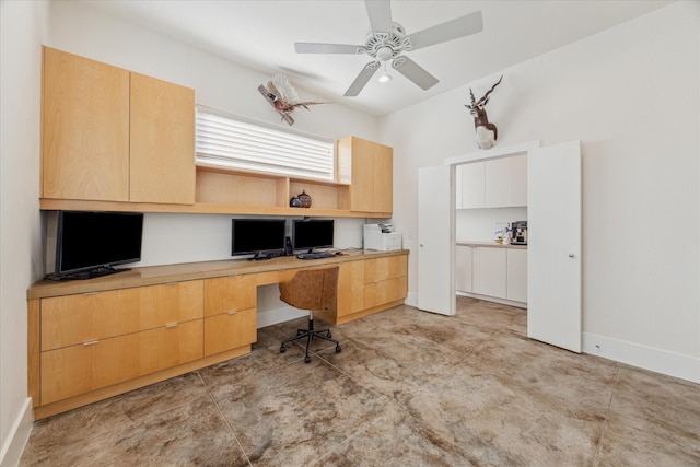 office space featuring built in desk and ceiling fan