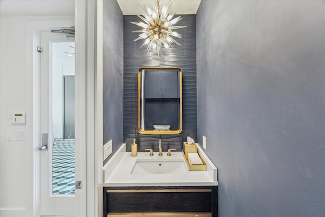 bathroom featuring vanity and a chandelier